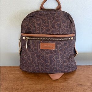 Calvin Klein Monogram Brown Backpack. (Use)Good condition.